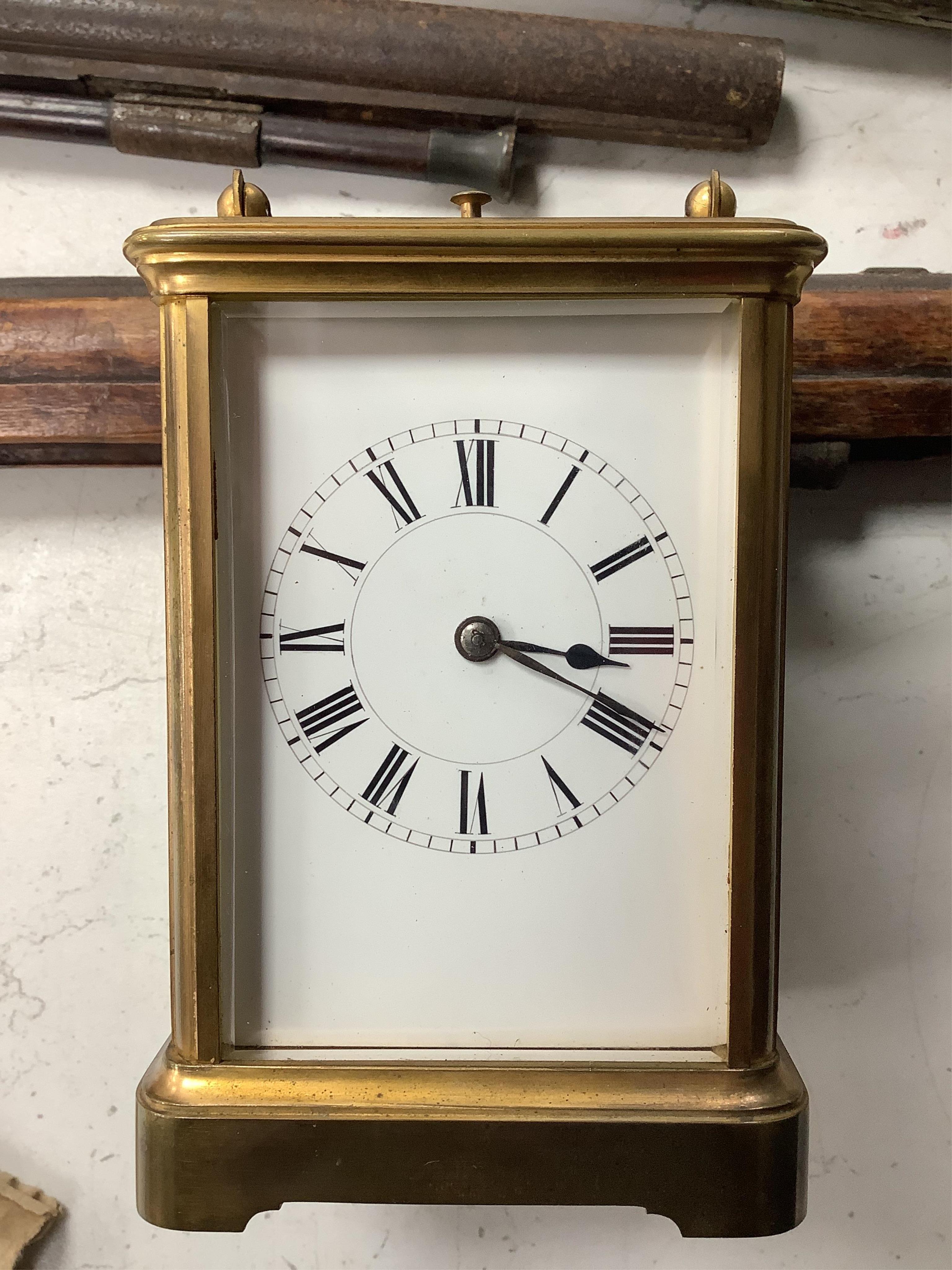 A late 19th century lacquered brass repeating carriage clock, by Henri Jacot and an Edwardian inlaid mantel timepiece with key, largest 23cm high